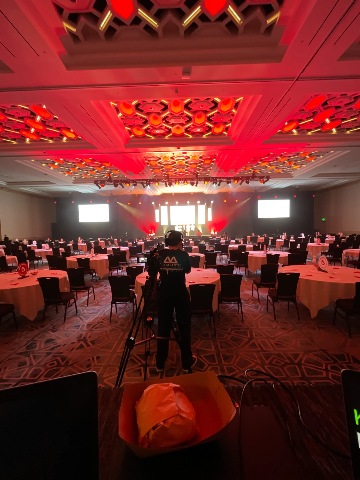 Red-lit ballroom event setup